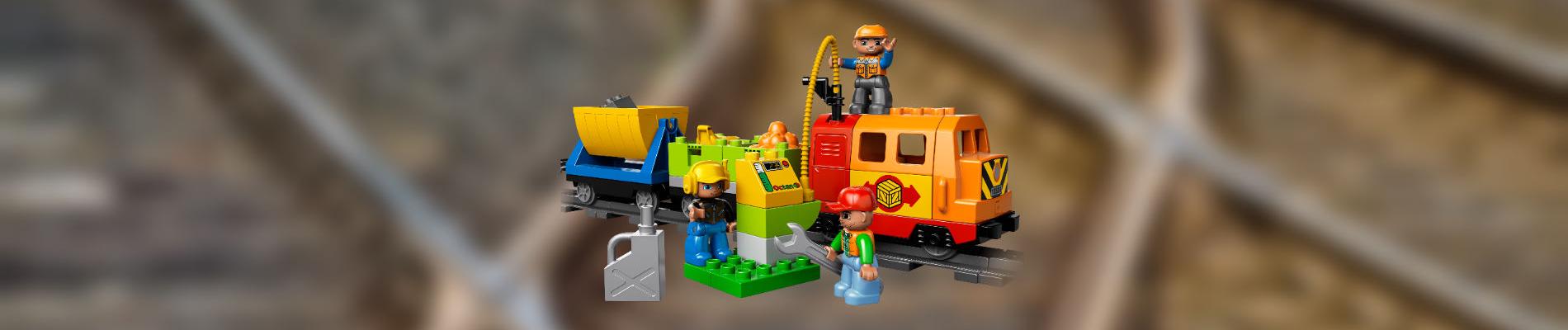 Lego Duplo train engine with blurred train rails as background